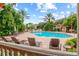 Relaxing lounge chairs surround the community pool, lined with tropical plants and trees at 4178 Central Sarasota Pkwy # 325, Sarasota, FL 34238