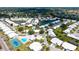 Community aerial view showcasing ponds, houses, streets, and amenities such as the pool and tennis court at 4181 Brittany Ln # 25, Sarasota, FL 34233