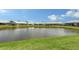 Expansive backyard with a peaceful pond view, manicured lawn, and well-maintained landscaping at 4181 Brittany Ln # 25, Sarasota, FL 34233