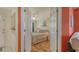 Comfortable bedroom with neutral decor and hardwood floors is viewed from between the open doorways at 4181 Brittany Ln # 25, Sarasota, FL 34233