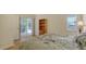 Well-lit bedroom with a view of the screened patio through sliding doors, featuring a large window at 4181 Brittany Ln # 25, Sarasota, FL 34233
