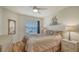 Comfortable bedroom featuring a ceiling fan, neutral walls, warm-toned bedding, and matching nightstands at 4181 Brittany Ln # 25, Sarasota, FL 34233