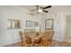 Bright dining area featuring a wooden table with chairs, wood floors, and a window to the kitchen at 4181 Brittany Ln # 25, Sarasota, FL 34233