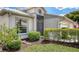 Charming single-story home with well-maintained landscaping, including green grass, bushes, and mulch at 4181 Brittany Ln # 25, Sarasota, FL 34233