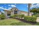 Lovely single-story home showcasing beautiful landscaping, a manicured lawn, and an American flag at 4181 Brittany Ln # 25, Sarasota, FL 34233