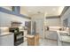 Well-lit kitchen equipped with stainless steel appliances, white cabinetry, and a modern design at 4181 Brittany Ln # 25, Sarasota, FL 34233