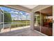 Enjoy serene lake views from the screened-in lanai, accessible via sliding glass doors at 4181 Brittany Ln # 25, Sarasota, FL 34233
