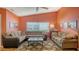 Comfortable living room with vaulted ceilings, a large sectional sofa, and hardwood floors at 4181 Brittany Ln # 25, Sarasota, FL 34233