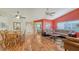 Open-concept living space with hardwood floors seamlessly connecting the living and dining areas at 4181 Brittany Ln # 25, Sarasota, FL 34233