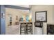 Cozy living area with breakfast bar, mini refrigerator, and easy access to the main living space at 4181 Brittany Ln # 25, Sarasota, FL 34233