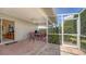 Relaxing screened-in patio featuring a ceiling fan, outdoor seating and a grill, accessible from the living area at 4181 Brittany Ln # 25, Sarasota, FL 34233