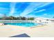 Outdoor pool surrounded by lounge chairs and well-maintained landscaping at 4181 Brittany Ln # 25, Sarasota, FL 34233