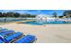 A large outdoor pool is surrounded by lounge chairs and features a tennis court at 4181 Brittany Ln # 25, Sarasota, FL 34233