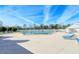 Large outdoor pool with lounge chairs and a tennis court in the background at 4181 Brittany Ln # 25, Sarasota, FL 34233