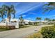 Crestwood Villas entrance with well-maintained landscaping, bright blue sky, and manicured lawns at 4181 Brittany Ln # 25, Sarasota, FL 34233