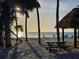 Picturesque beach setting with picnic tables, shady trees and tranquil ocean views at 4408 Midnight Pass Rd, Sarasota, FL 34242