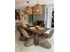 Bright and airy dining room with woven chairs and a wooden table at 4408 Midnight Pass Rd, Sarasota, FL 34242