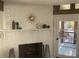 Fireplace featuring a white-painted brick surround and a vintage-style clock at 4408 Midnight Pass Rd, Sarasota, FL 34242
