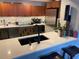 Bright kitchen featuring stone countertops, stainless steel appliances, and ample cabinet space at 4408 Midnight Pass Rd, Sarasota, FL 34242