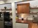 Efficient kitchen with stainless steel appliances, wooden countertops, and open shelving at 4408 Midnight Pass Rd, Sarasota, FL 34242