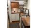 Modern kitchen features wood countertops, a stainless steel sink, and open shelving at 4408 Midnight Pass Rd, Sarasota, FL 34242