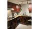 Kitchen featuring wood cabinets, granite counters, and stylish geometric backsplash at 4408 Midnight Pass Rd, Sarasota, FL 34242