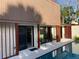 Modern backyard features a private pool with sleek lounge chairs and a covered patio at 4408 Midnight Pass Rd, Sarasota, FL 34242