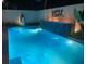 Stunning backyard pool with lit waterfall feature, elegant tiling, and lush greenery at 4408 Midnight Pass Rd, Sarasota, FL 34242