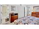 Bedroom showcasing ample storage with a wooden dresser and closet, complemented by neutral carpeting at 4632 Ringwood Mdw # 28, Sarasota, FL 34235