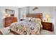This cozy bedroom features a decorative comforter set, matching nightstands, and dresser for a harmonious design at 4632 Ringwood Mdw # 28, Sarasota, FL 34235