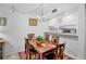 Bright dining area adjacent to the kitchen with modern lighting and a four-chair table at 4632 Ringwood Mdw # 28, Sarasota, FL 34235