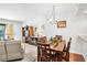 Bright dining area adjacent to the living room, with a dining table set for four at 4632 Ringwood Mdw # 28, Sarasota, FL 34235