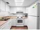 This well-lit kitchen features clean white appliances and ample cabinet space for convenient storage and functionality at 4632 Ringwood Mdw # 28, Sarasota, FL 34235