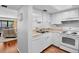 Compact kitchen features white cabinets, laminate countertops, and essential appliances for easy meal preparation at 4632 Ringwood Mdw # 28, Sarasota, FL 34235