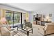 Bright living room features a screened lanai, comfortable seating, and neutral carpeting at 4632 Ringwood Mdw # 28, Sarasota, FL 34235