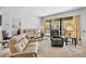 Cozy living room with access to the lanai overlooking the community pool, with comfortable seating at 4632 Ringwood Mdw # 28, Sarasota, FL 34235