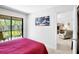 Comfortable main bedroom with access to the balcony and a view of the lush surroundings at 4632 Ringwood Mdw # 28, Sarasota, FL 34235