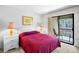 Serene main bedroom with private access to the balcony and light neutral paint colors at 4632 Ringwood Mdw # 28, Sarasota, FL 34235