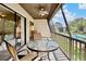 Inviting screened patio with comfortable seating, ceiling fan, and scenic views of the community pool at 4632 Ringwood Mdw # 28, Sarasota, FL 34235