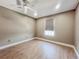 Empty bedroom featuring wood-look floors, a ceiling fan, and a window at 4850 51St W St # 4205, Bradenton, FL 34210