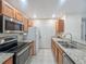 Galley-style kitchen with stainless steel appliances and granite countertops at 4850 51St W St # 4205, Bradenton, FL 34210