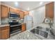 Functional kitchen featuring stainless steel appliances, granite countertops, and ample cabinet space at 4850 51St W St # 4205, Bradenton, FL 34210