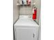 A laundry area showcases a white clothes dryer and shelf for storing supplies at 4850 51St W St # 4205, Bradenton, FL 34210