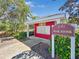 Exterior view of the community mail kiosk featuring a red building and community signage at 4850 51St W St # 4205, Bradenton, FL 34210