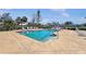 Community pool surrounded by lounge chairs, perfect for relaxing and enjoying the outdoors at 4850 51St W St # 4205, Bradenton, FL 34210