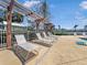 The community pool area features lounge chairs and a trellis for shade by the sparkling pool at 4850 51St W St # 4205, Bradenton, FL 34210