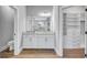 Bright primary bath featuring a toilet, a sink, and an adjacent closet with closet system at 4984 Seafoam Trl, Bradenton, FL 34211
