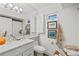 Bright bathroom with white vanity, and artwork at 5055 Gulf Of Mexico Dr # 115, Longboat Key, FL 34228