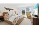 Bright bedroom features a large window, plush carpet, and a comfortable bed with colorful floral bedding at 5055 Gulf Of Mexico Dr # 115, Longboat Key, FL 34228