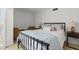 Simple bedroom with an iron bed frame, throw pillows and 2 arm chairs at 5055 Gulf Of Mexico Dr # 115, Longboat Key, FL 34228